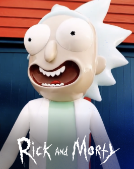 Rick smiling in a white coat and mint green shirt, close up